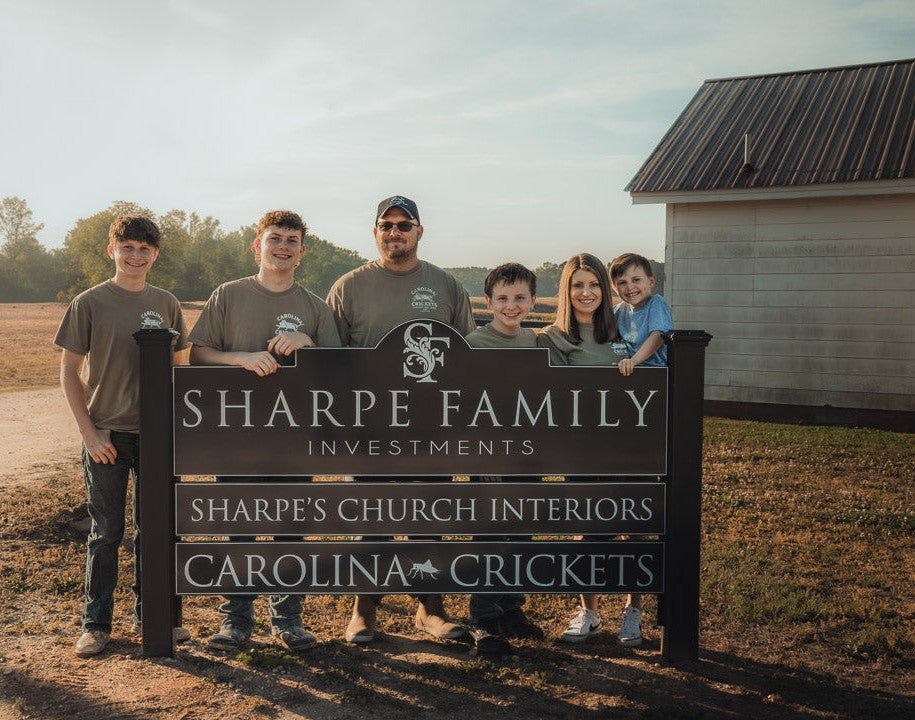 The Sharpe family at the Carolina Crickets farm sign in Dunn, NC